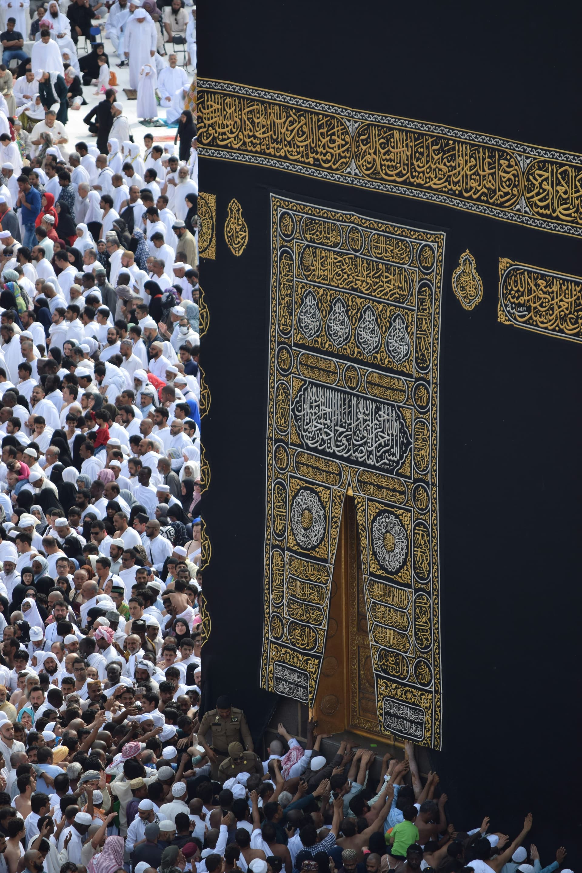 Muslims gathering for Jummah prayers at a mosque with beautiful Islamic architecture
